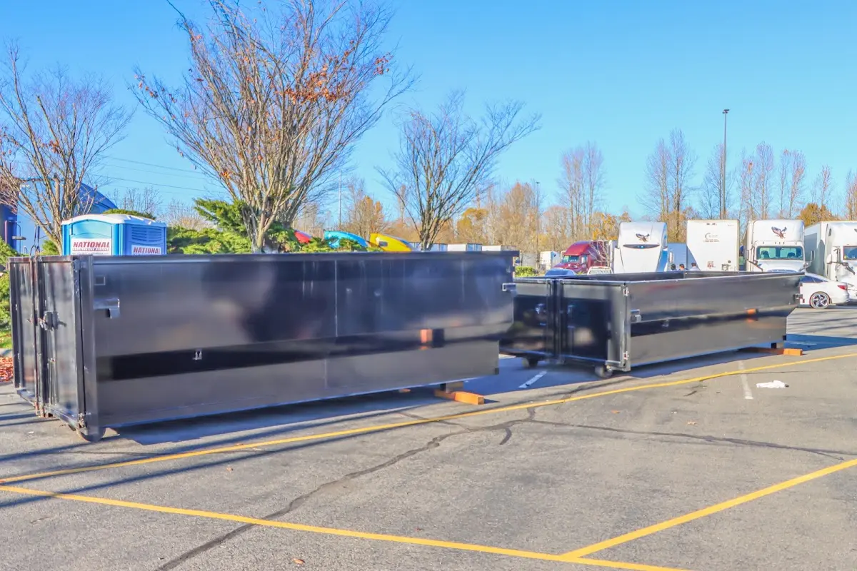 Professional dumpster rental service with roll-off container on residential driveway in Hermantown